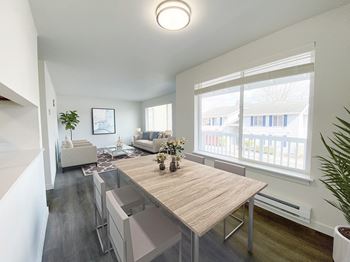 A dining room with a wooden table and a large window